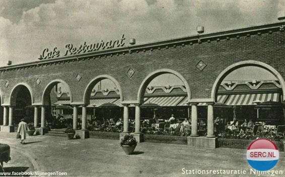 Nijmegen: Het Stationsplein in 1959 met de arcadebogen langs het terras van de stationsrestauratie van het N.S.-station Nijmegen. Daar waar de Nijmegenaar nog gezellig kon borrelen.